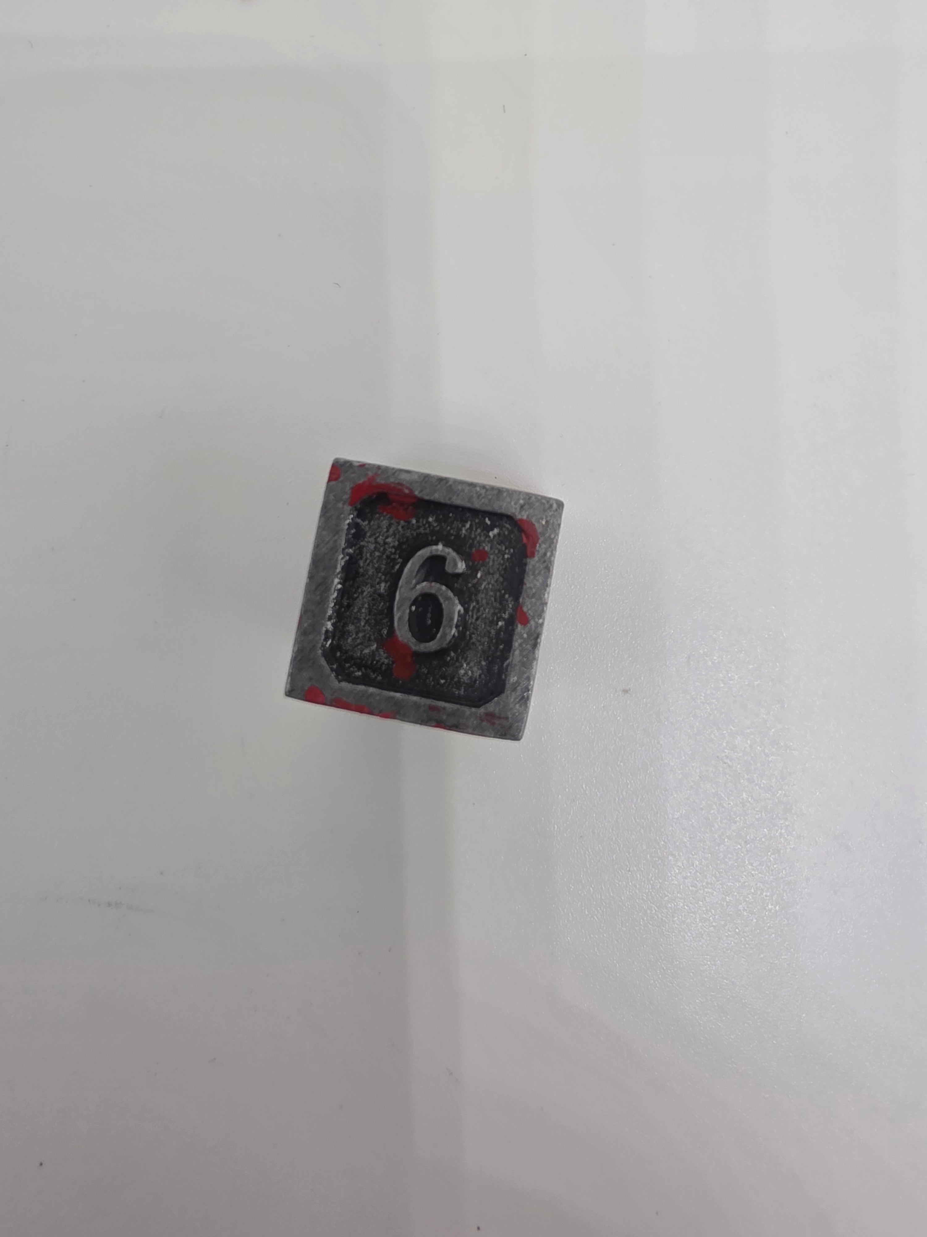 Solid metal blood splatter dice set