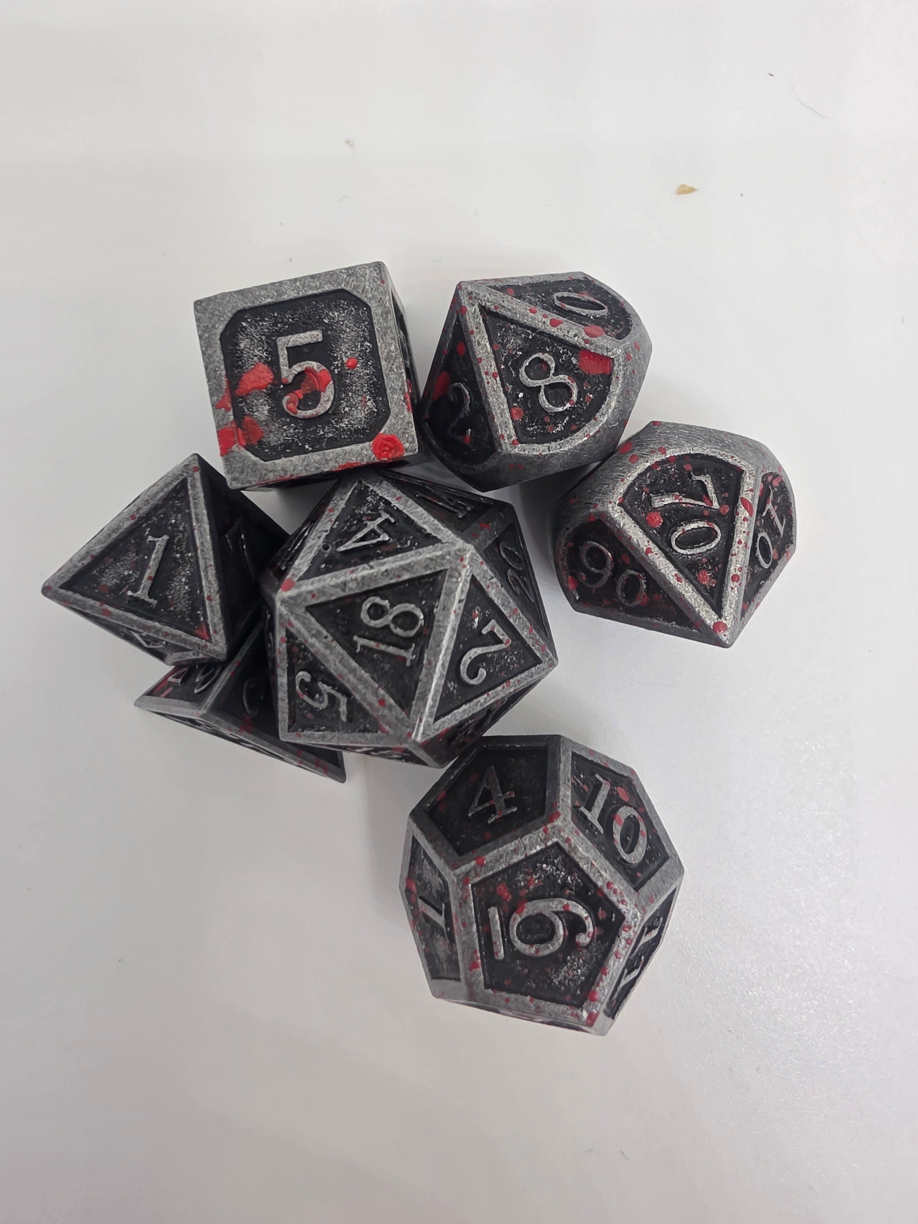 Solid metal blood splatter dice set