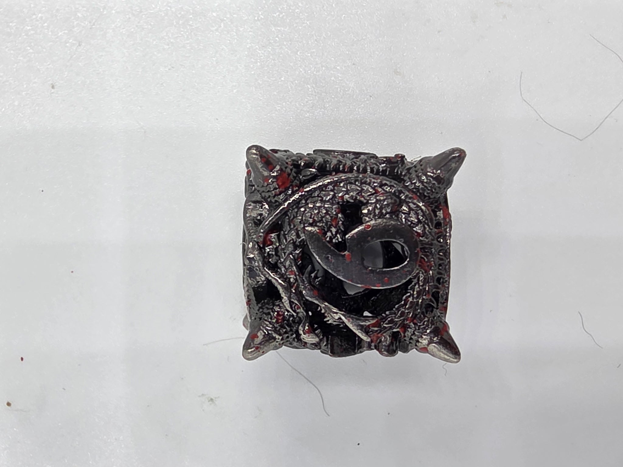 Hollow metal blood splatter dice set