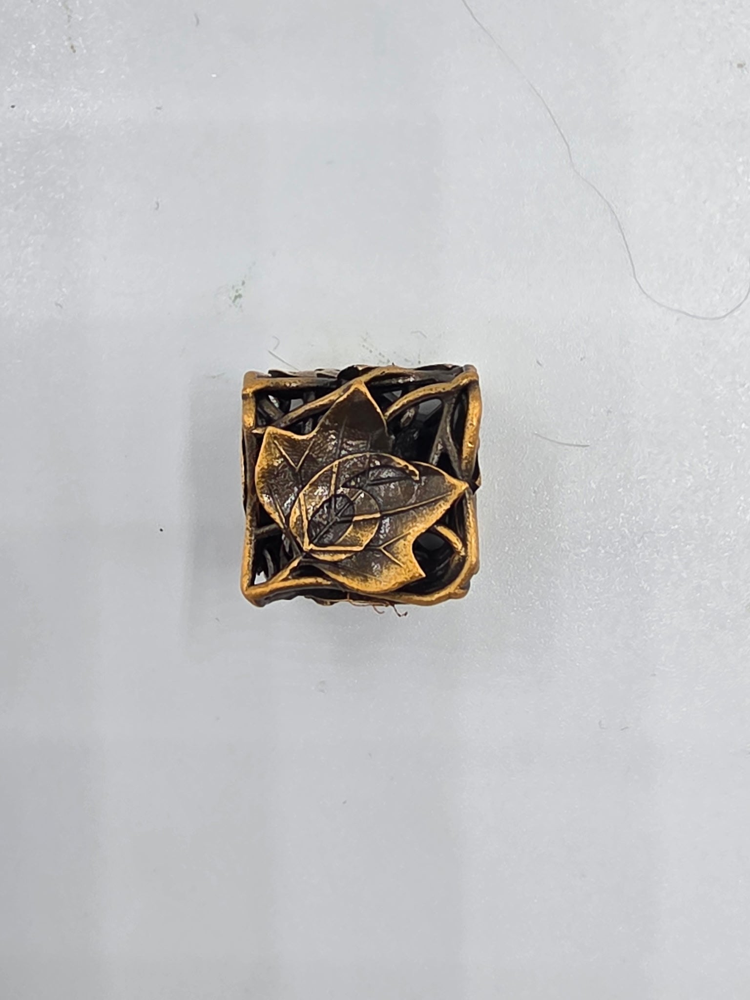 Hollow bronze leaf dice set