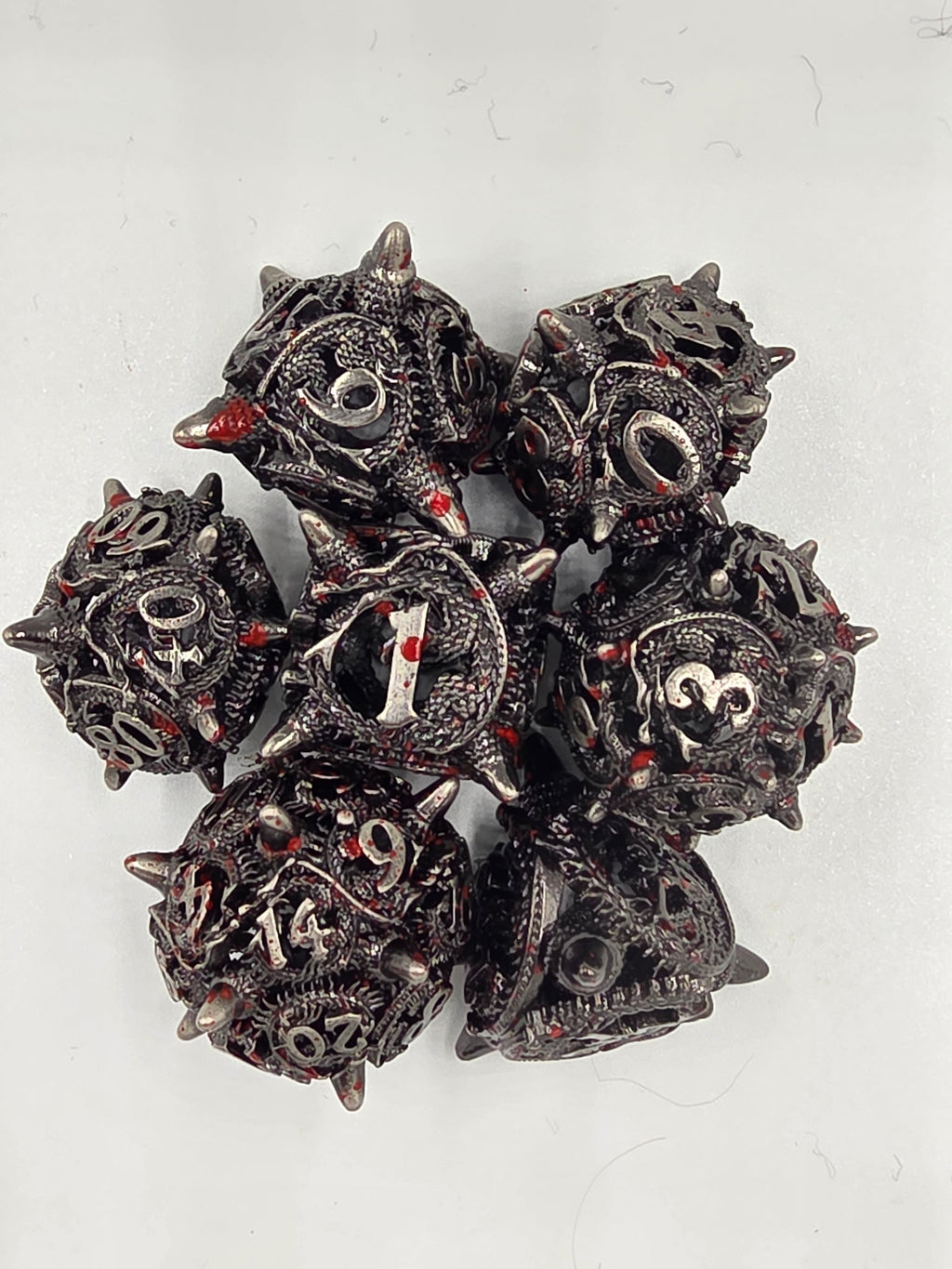 Hollow metal blood splatter dice set