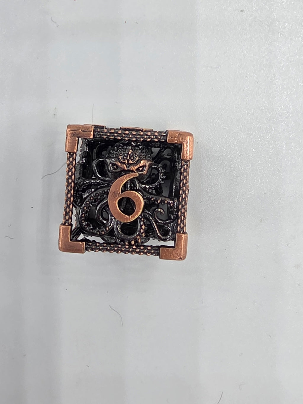 Hollow metal Kraken’s Cage dice set