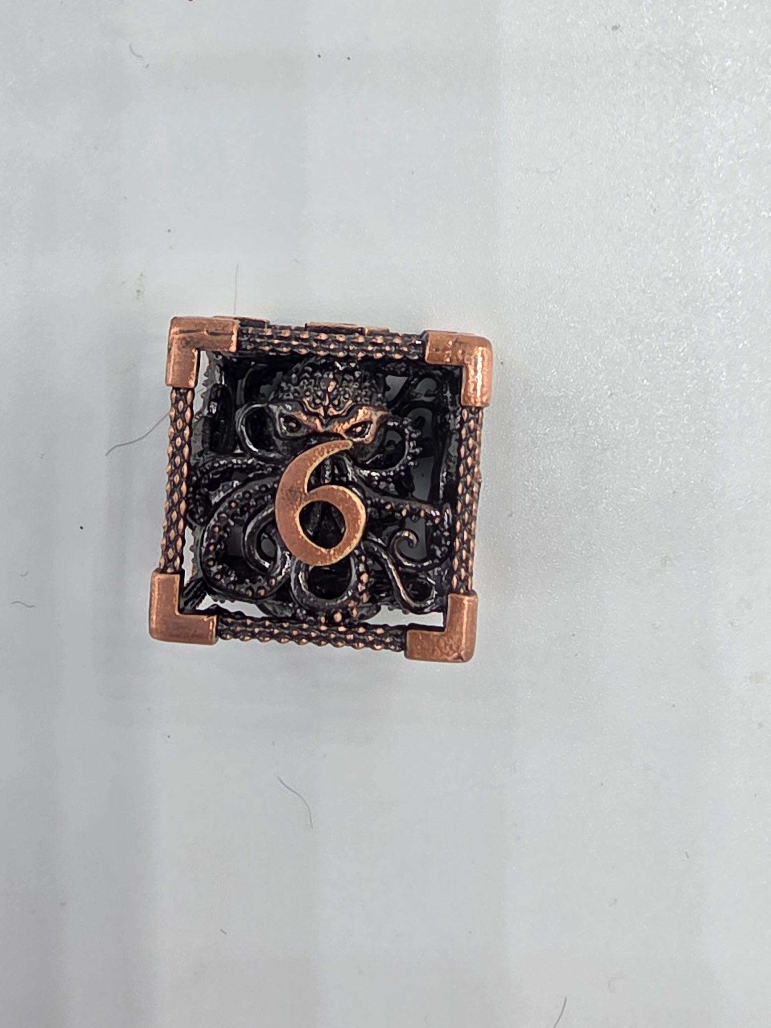 Hollow metal Kraken’s Cage dice set